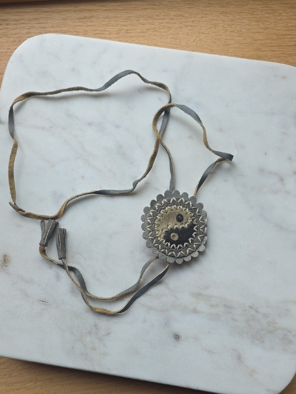 handmade yin-yang symbol pendant made of leather